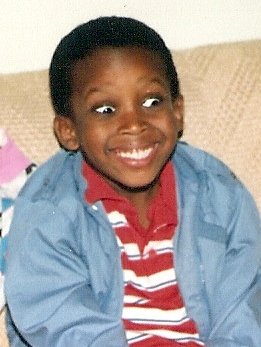 Marcus smiling as a child